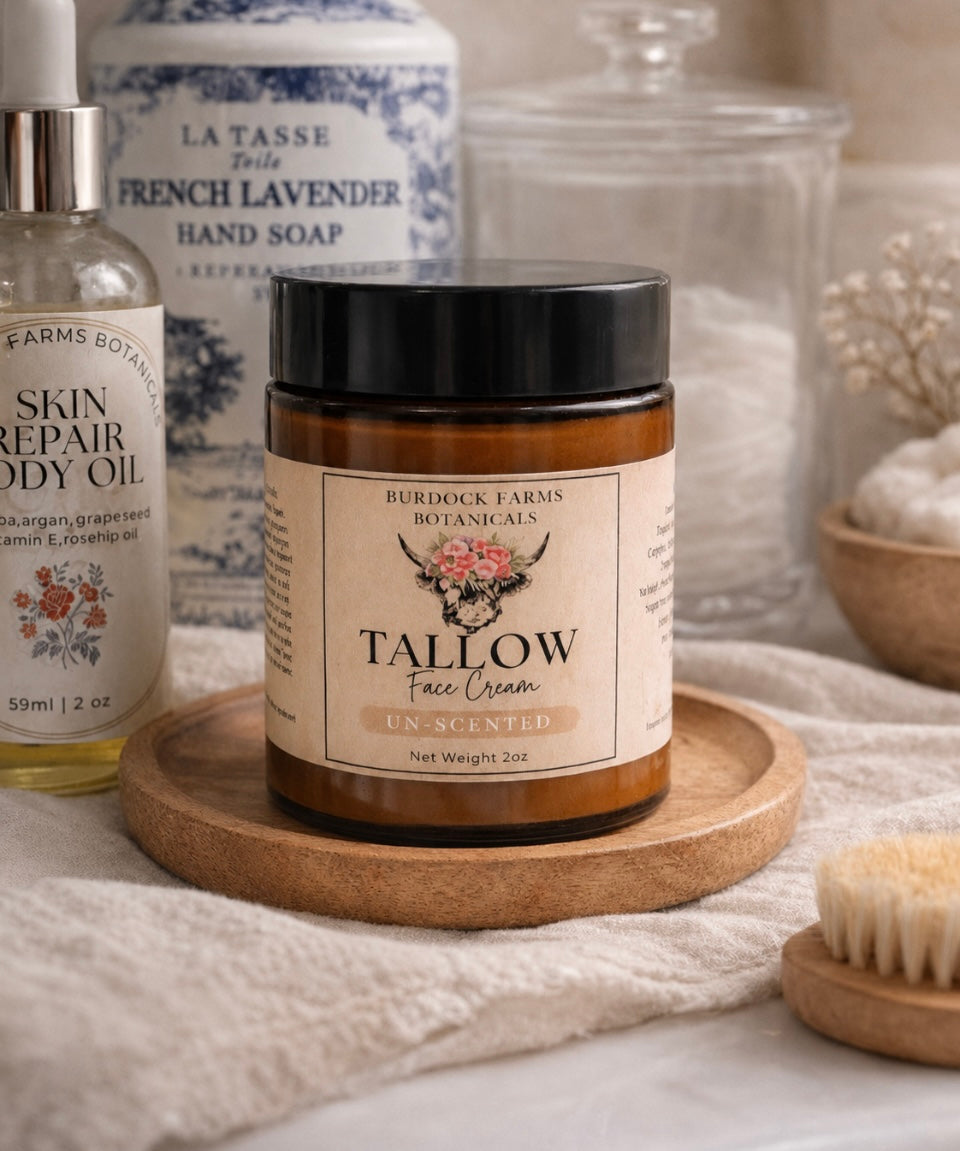 Whipped grass fed tallow face cream amber jar on wooden tray by Burdock Farms Botanicals