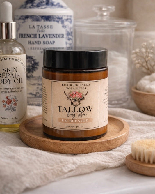 Whipped grass fed tallow body lotion 6oz amber jar on wooden tray by Burdock Farms Botanicals